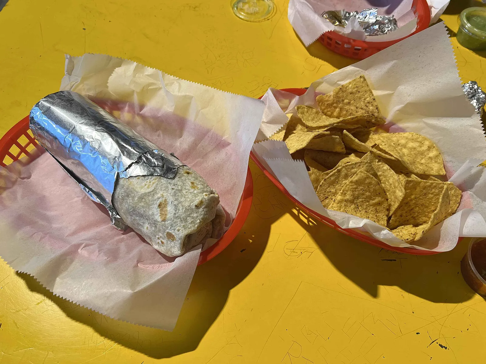 Foil-wrapped Mission burrito with tortilla chips